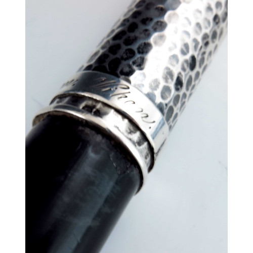 29 - A Swedish silver handled walking cane, circa 1910, the planished crook top with plain band, on an eb... 