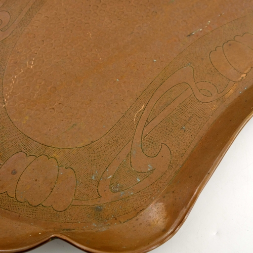 520 - J F Pool, Hayle, an Arts and Crafts copper tray, kidney form, embossed planished ground within an Ar... 