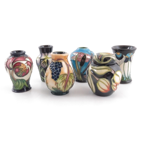 629 - A boxed set of six Moorcroft miniature vases, various designs and shapes, circa 2005, including ging... 