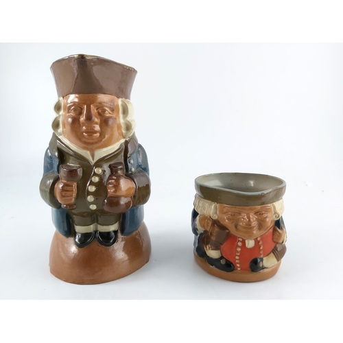 662 - Harry Simeon for Doulton Lambeth, two stoneware Toby jugs, one modelled with bottle and wine glass, ... 