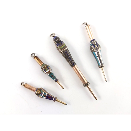 297 - Four gold plated and enamelled novelty Egyptian revival propelling pencils, circa 1920s, modelled as... 