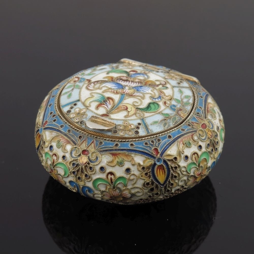 13 - A Russian silver cloisonne enamel snuff box, of circular form, the hinged cover with a floral design... 