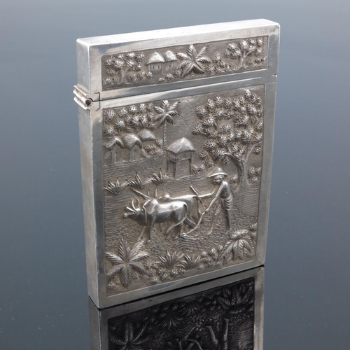 3 - A large Indian white metal card case, 19th century, embossed in relief and chased with agricultural ... 