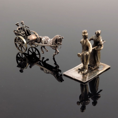 37 - A Continental white metal miniature of a couple in a horse-drawn carriage, together with a miniature... 