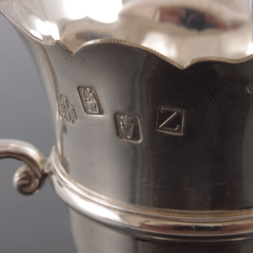 57 - An Elizabeth II Irish silver jug, Royal Irish Silver Ltd., Dublin 1967, banded rounded helmet form w... 