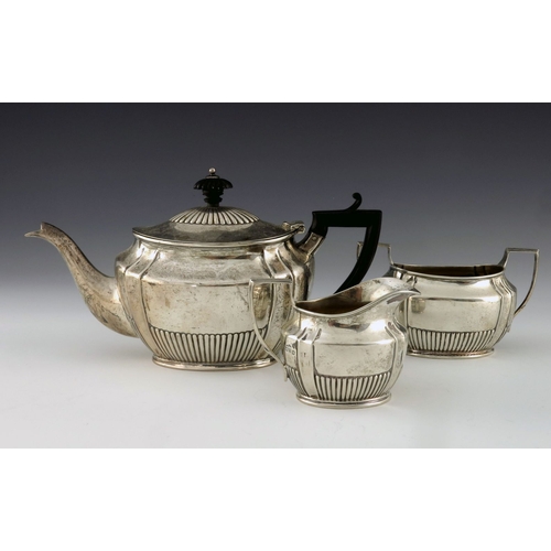 64 - A Victorian silver three piece tea set, Lowe and Sons, Chester 1900, ogee boat form, with fluted str... 