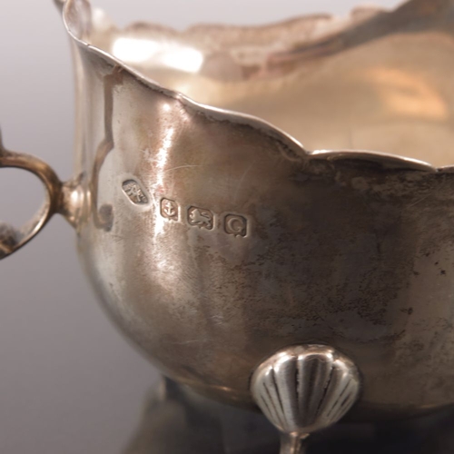 81 - A pair of George V silver sauce boats, Adie Brothers, Birmingham 1931, ogee rimed helmet form, with ... 