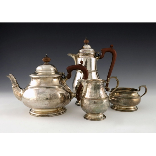 99 - A George VI silver four piece tea set, F C Richards, Birmingham 1937, banded baluster form with ear ... 