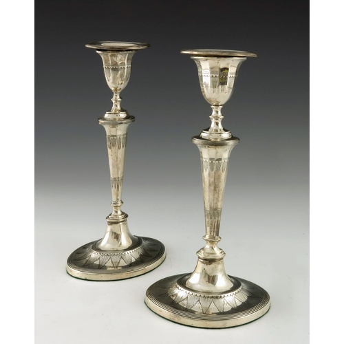 105 - A matched pair of Victorian and Edwardian silver candlesticks, Thomas Bradbury, London 1897 and 1903... 