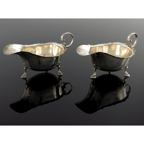 109 - A pair of George V silver sauce boats, Asprey and Co., Birmingham 1929/30, ogee rimmed helmet form w... 