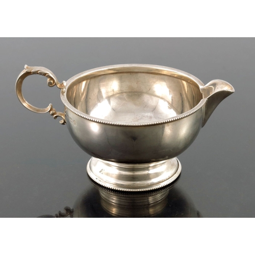 113 - A George V silver jug, Henry Clifford Davis, Birmingham 1924, hemispherical and footed form with bea... 