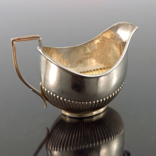 114 - An Edwardian silver jug, John Rose, Birmingham 1907, half reeded boat form with angular handle, 12.5... 