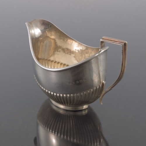 114 - An Edwardian silver jug, John Rose, Birmingham 1907, half reeded boat form with angular handle, 12.5... 