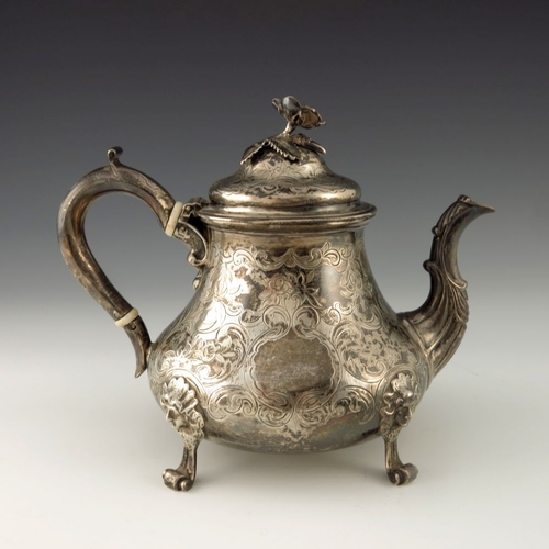 116 - A Victorian silver teapot, Edward Pairpoint and George Wood, London 1856, baluster form, chased with... 