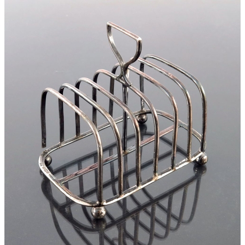 119 - A Victorian silver six division toast rack, James Dixon and Sons, Sheffield 1895, plain wire constru... 