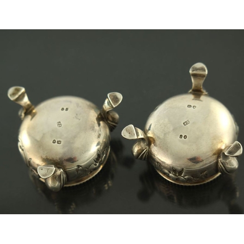 125 - A pair of Victorian silver salt cellars, Beare Falcke, London 1866, cauldron form, embossed with flo... 