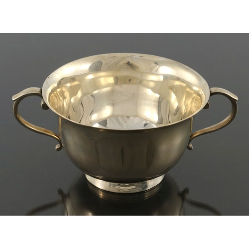 126 - A George V silver twin handled cup, Thomas Edward Atkins, Birmingham 1914, footed ogee form with S s... 