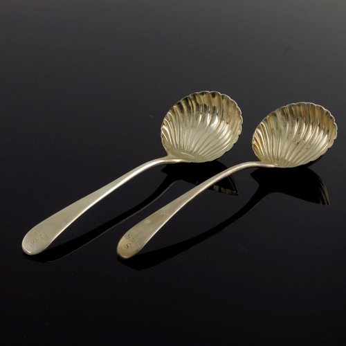 134 - A pair of George III silver sauce ladles, Thomas and William Chawner, London 1768, Old English with ... 