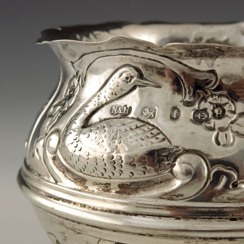 136 - A Victorian silver bowl, Nathan and Hayes, Birmingham 1893, cauldron form, embossed in relief with v... 