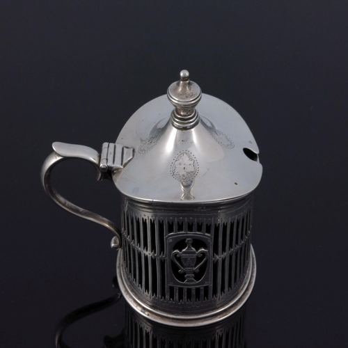 138 - An Edwardian reticulated silver mustard pot, George Fox, London 1905, oval section, bright cut and p... 