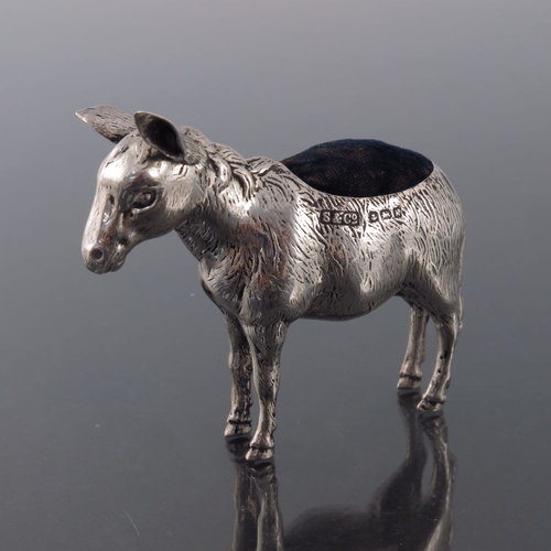 185 - An Edwardian novelty silver pin cushion, Sydney and Co., Birmingham 1909, modelled as a donkey, stan... 