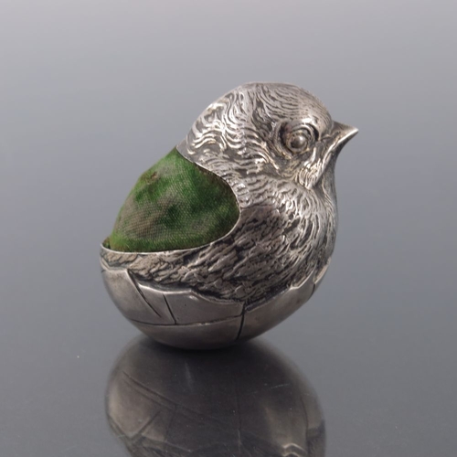 186 - An Edwardian novelty silver pin cushion, Sampson Mordan, Chester 1905, modelled as a chick emerging ... 