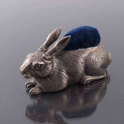 189 - An Elizabeth II novelty silver pin cushion, John Bull Ltd., London 1987, modelled as a hare, seated,... 