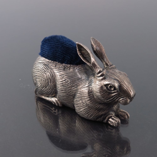 189 - An Elizabeth II novelty silver pin cushion, John Bull Ltd., London 1987, modelled as a hare, seated,... 