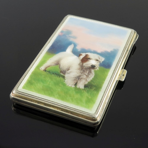 201 - A George V silver enamel cigarette case, the cover painted with a terrier dog in a grassy landscape,... 