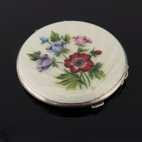 205 - Three silver circular powder compacts, in cream guilloche enamel and painted with various flowers, a... 