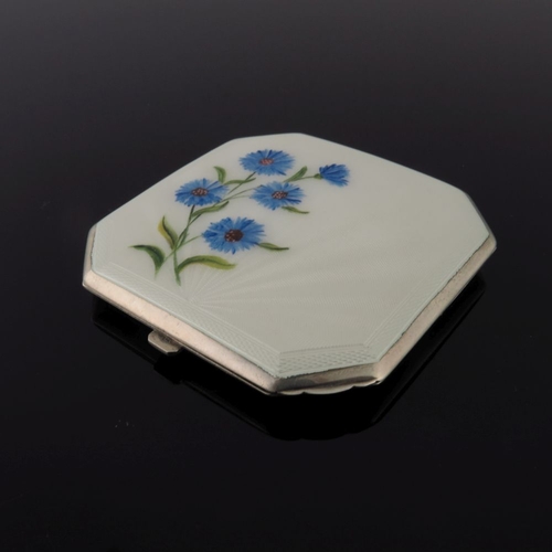 209 - A silver octagonal powder compact in cream guilloche enamel with painted cornflowers, a circular cre... 