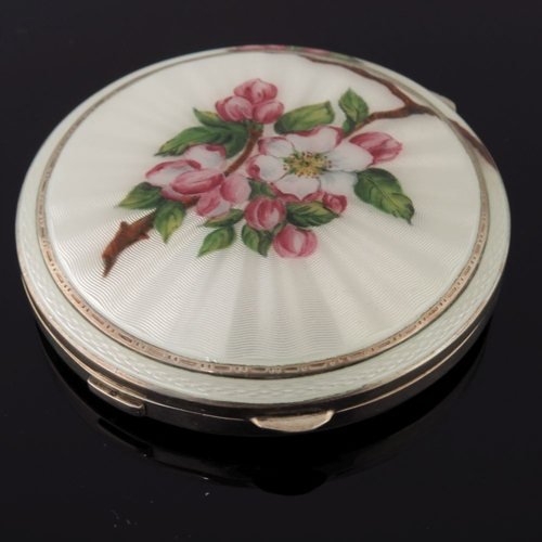 211 - A George VI silver enamel square powder compact, the cover with apple blossom on a cream guilloche g... 