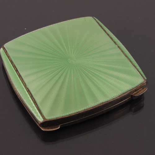 224 - A George VI silver gilt and enamelled powder compact, Albert Carter, Birmingham 1937, sun burst desi... 