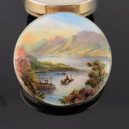 227 - A George V silver circular powder compact, the cover enamelled with a mountainous lake landscape, Bi... 