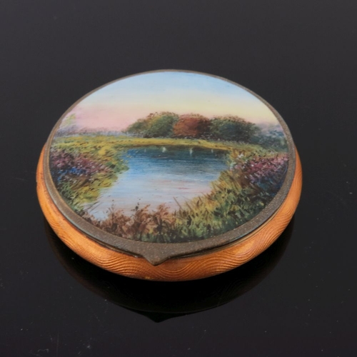 236 - A silver orange guilloche enamel powder compact, the lid with a river landscape, together with three... 