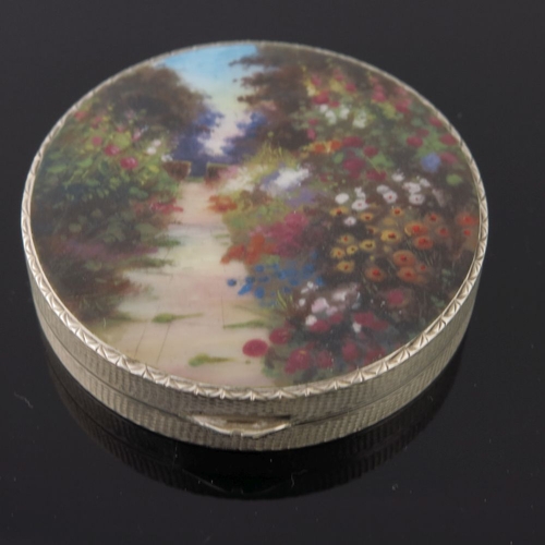 236 - A silver orange guilloche enamel powder compact, the lid with a river landscape, together with three... 