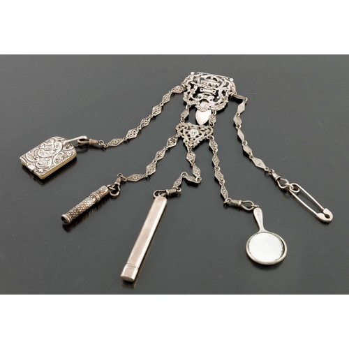 237 - An Edwardian silver chatelaine, Reynolds and Westwood, Birmingham 1902, cast and reticulated in the ... 