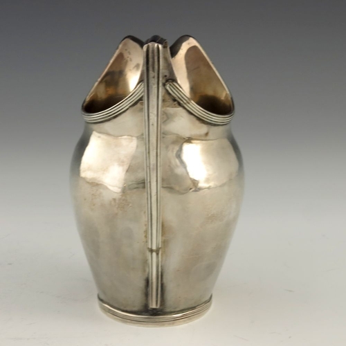 252 - A George III silver cream jug, Crispin Fuller overstruck Samuel Godbehere, London 1795, helmet form ... 