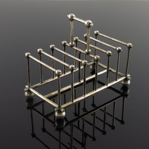 255 - After Christopher Dresser, a silver plated six division toast rack, James Dixon, circa 1890, ball an... 