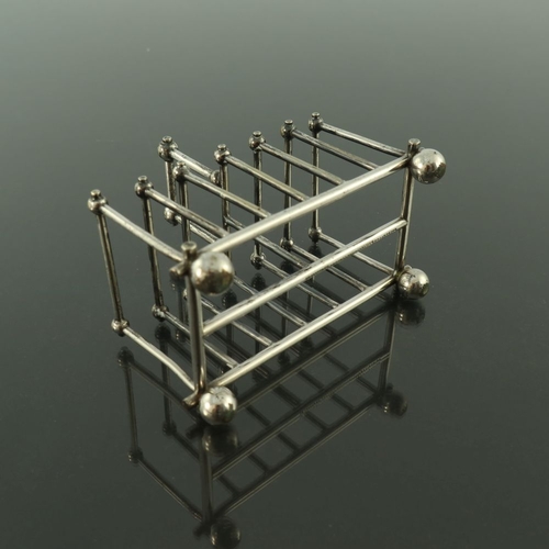 256 - After Christopher Dresser, a silver plated six division toast rack, Goldsmiths and Silversmiths Comp... 