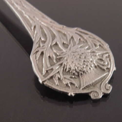 272 - Alwyn Carr, an Arts and Crafts silver spoon, London 1920, planished and cast with a thistle terminal... 