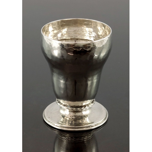 273 - Omar Ramsden, an Arts and Crafts silver footed beaker, London 1922, planished ogee form, with applie... 