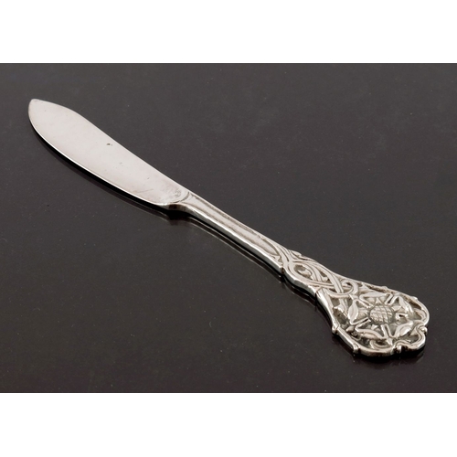 274 - Omar Ramsden, an Arts and Crafts silver butter knife, London 1935, cast and planished with a  knotte... 