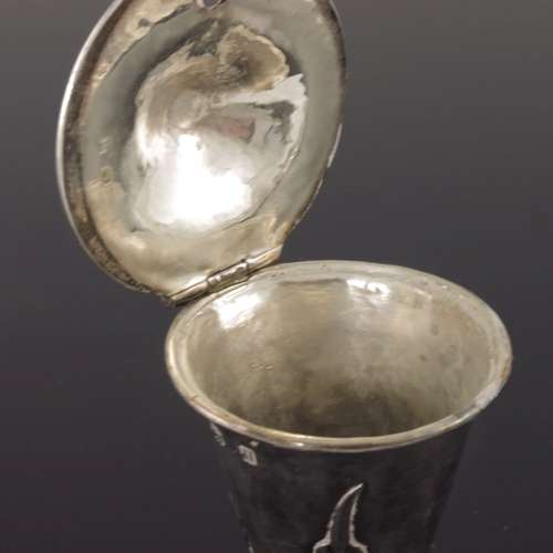 276 - A E Jones, an Arts and Crafts silver mustard pot, Birmingham 1912, flare footed conical form, applie... 