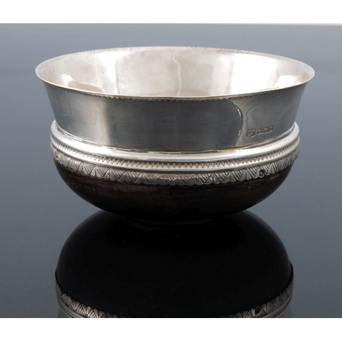 279 - A George V silver mazer bowl, D and M Davis, Sheffield 1929, turned wooden base with flared rim, geo... 