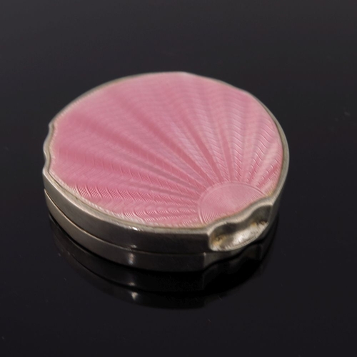 293 - A pink guilloche enamel circular powder compact together with an Art Deco guilloche pink enamel powd... 