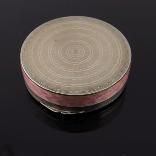 293 - A pink guilloche enamel circular powder compact together with an Art Deco guilloche pink enamel powd... 