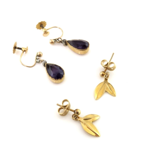 318 - Two 9ct gold earrings, to include a pair of early 20th century amethyst and diamond drop earrings, a... 