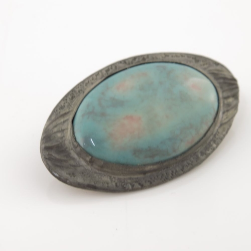 326 - Ruskin, an Arts and Crafts pewter mounted enamel brooch, circa 1915, the oval plaque in mottled blue... 