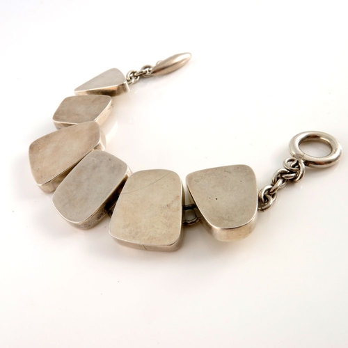 332 - A Modernist silver bracelet, designed as a series of vari-shape polished panels, with toggle clasp, ... 